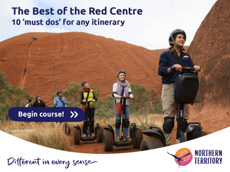 Tourists on Segway machines riding around Uluru